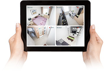 Women hands holding iPad displaying closed circuit camera system